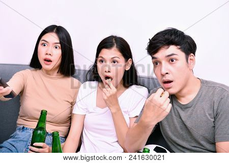 Concept Of Cheering. Asian Teenagers Watching Football On Television. People Are Cheering And Winnin