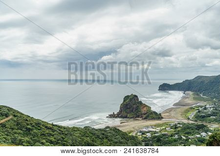 Aerial View Of Seashore And Rocky Cliffs On Cloudy Day, Piha Beach, New Zealand