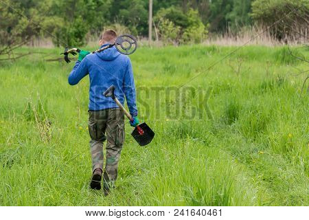 Man To Seek Treasure On Earth With A Metal Detector, Walks The Field, Squeak Gold