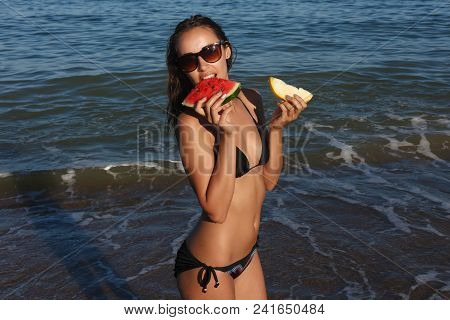 Summer Vacation - Young Girl Eating Fresh Watermelon On Sandy Beach