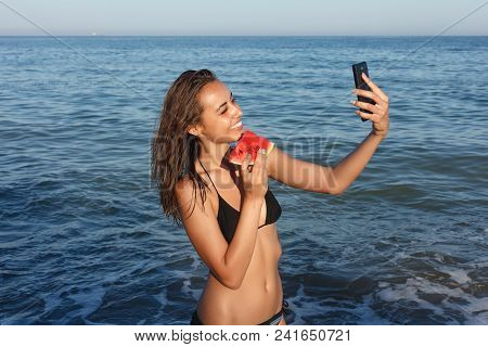 Summer Vacation - Young Girl Eating Fresh Watermelon On Sandy Beach