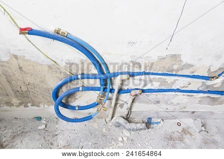 Water Pipes Made Of Polypropylene Pex In The Wall, Plumbing In The House. Installation Of Sewer Pipe