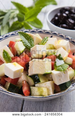Greek salad with feta cheese cubes and fresk vegetables