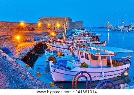 Port of Heraklion with old fishing boats at twilight  Crete, Greece