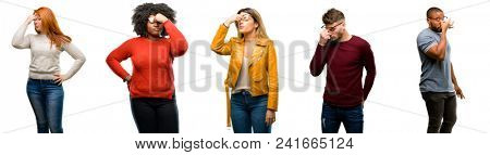 Group of cool people, woman and man with sleepy expression, being overworked and tired, rubbes nose because of weariness