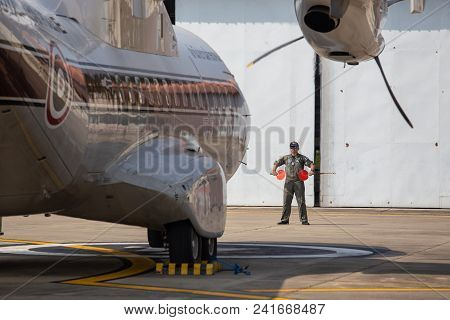 Hua Hin,thailand- October 31,2017: Aircraft Marshaller Standby For Signal To Pilot Of Casa/iptn Cn-2