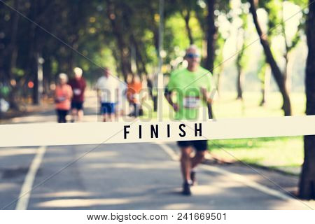 Mature man running towards the finish line