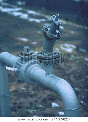 Flanges And Valves Are Mounted On A Ground Made Of Welded Steel Pipes. Metal Pipe Flanges With Bolts