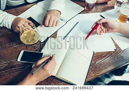 Young Cheerful People Smile And Gesture While Relaxing In Pub. Team Job. Photo Young And Mature Busi