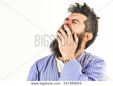 Hipster With Beard And Mustache With Messy Hair Wears Bathrobe, Close Up. Man With Yawning Sleepy Fa