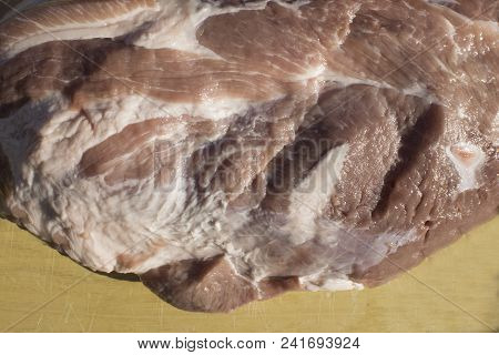 Overhead View Of Raw Piece Of Pork On Wooden Background. Big Piece Of Fresh Boneless Pork, Neck Part
