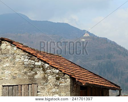 Old House And The Ancient Church Of Saint Peter On The Mount In Northern Italy