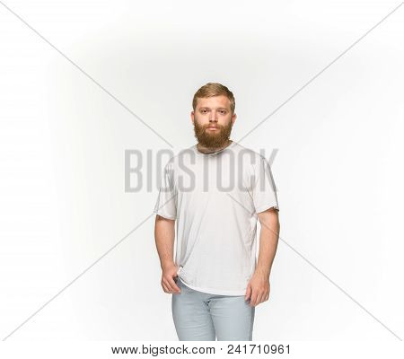 Closeup Of Young Man's Body In Empty White T-shirt Isolated On White Background. Mock Up For Disign 