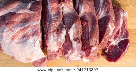 Raw Fat Cuting Pieces Of Pork On Wooden Background. Piece Of Fresh Boneless Pork, Neck Part Or Colla