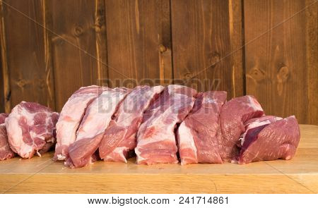 Raw Fat Cuting Pieces Of Pork On Wooden Background. Piece Of Fresh Boneless Pork, Neck Part Or Colla