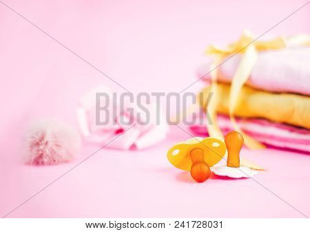 Newborn Stuff, Clothes And Pacifier For Baby Girl On Pink Background