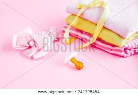 Newborn Stuff, Clothes And Pacifier For Baby Girl On Pink Background