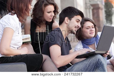 Group Of Fellow Students With Books And Laptop.education Concept