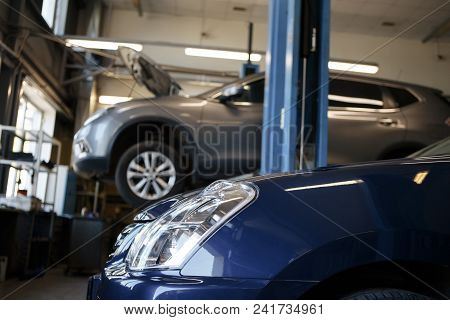 Black Car Repair Station With Soft-focus In The Background And Over Light