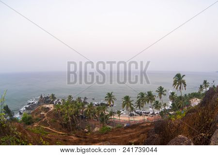 Morning Time On The Sea Beach With Rock And Palms