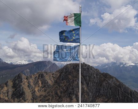 Italian And European Flags Blown By An Alpine Wind