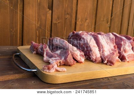 Raw Fat Cuting Pieces Of Pork On Wooden Background. Piece Of Fresh Boneless Pork, Neck Part Or Colla