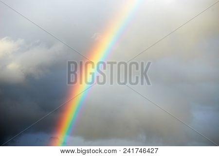 A Bright Rainbow On A Dark Stormy Sky.