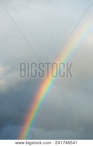 A Bright Rainbow On A Dark Stormy Sky.