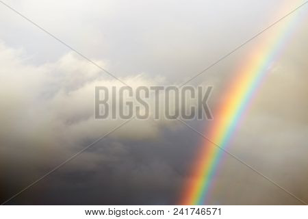 A Bright Rainbow On A Dark Stormy Sky.