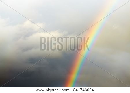 A Bright Rainbow On A Dark Stormy Sky.