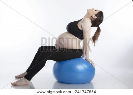 Pregnant Woman Is Doing Exercises With Gymnastic Ball On White Background