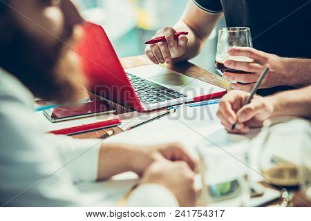 The Hands Of Young People Working And Relaxing In Pub. Team Job. Photo Businessmans Working With New