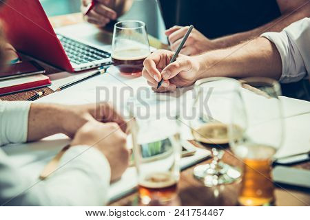 The Hands Of Young People Working And Relaxing In Pub. Team Job. Photo Businessmans Working With New