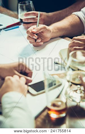 The Hands Of Young People Working And Relaxing In Pub. Team Job. Photo Businessmans Working With New