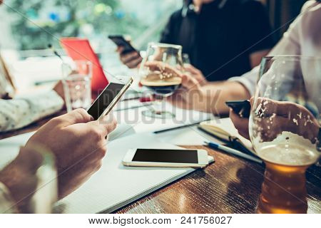 The Hands Of Young People Working And Relaxing In Pub. Team Job. Photo Businessmans Working With New