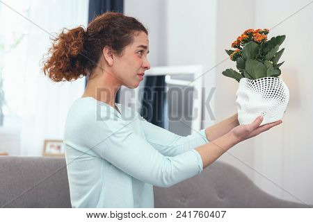 Life Choices. Young Woman Felling Sorry Saying Goodbye To Her Favourite Plants Entailing Her To Alle