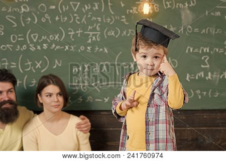 Happy Kid Having Fun. Wunderkind Concept. Smart Child, Wunderkind In Graduate Cap Pointing At His He