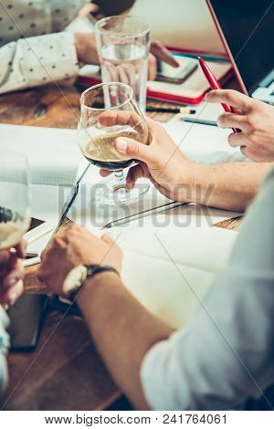 The Hands Of Young People Working And Relaxing In Pub. Team Job. Photo Businessmans Working With New