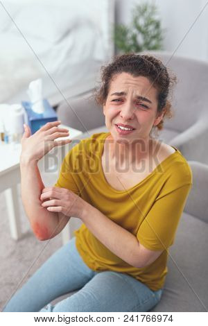 Awful Pain. Young Injured Woman Frowning Her Face In Pain While Terribly Suffering From Impossible P