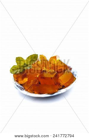 Orange Colored Halwa Grass Or China Grass Or Jelly In A Plate With Mint Leaves A Sweet Dessert Eaten