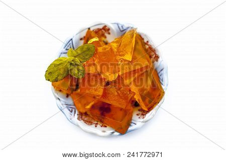 Orange Colored Halwa Grass Or China Grass Or Jelly In A Plate With Mint Leaves A Sweet Dessert Eaten