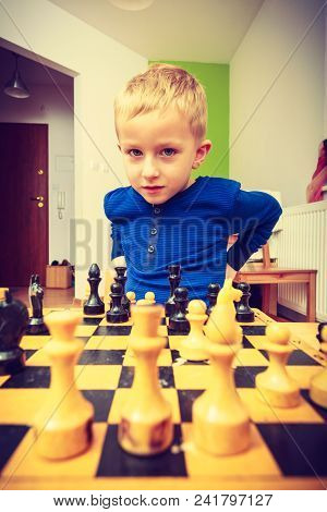 Intelligent, Smart Ass Kids, Games Good For Brain Intelligence Concept. Young Kid Boy Playing Chess 