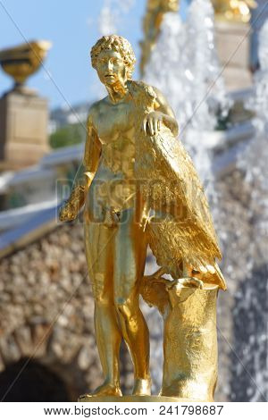 PETERHOF, ST. PETERSBURG, RUSSIA - MAY 10, 2018: Golden statues of the Grand Cascade. The cascade was built in 1715-1724 and is one of the remarkable fountain constructions in the world