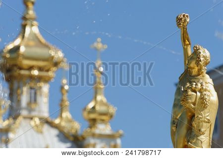 PETERHOF, ST. PETERSBURG, RUSSIA - MAY 10, 2018: Golden statues of the Grand Cascade. The cascade was built in 1715-1724 and is one of the remarkable fountain constructions in the world
