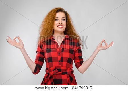 Charming Young Girl In A Checkered Cloth On A Gray Background