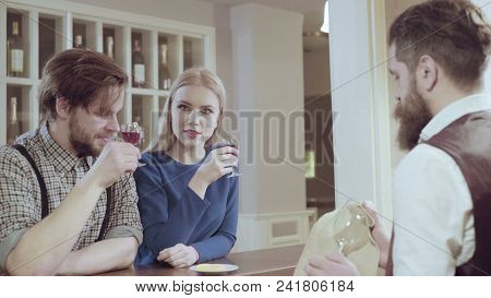 Attractive Elegant Young Couple Drinking A Cocktail At The Restaurant. Handsome Loving Couple Flirti