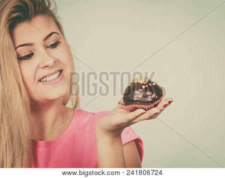 Diet, Sweets, Food Concept. Woman Holding Delicious Chocolate Cupcake With Peanut Frosting About To 