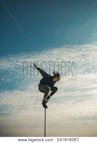 Athletic Guy Make Acrobatic Elements On Pylon. Strong Man Dancer Workout On Pole. Sexy Macho Man Fly