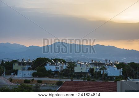 Dawn In Summer Over The City In The Mountains With Hanging Clouds On The Horizon At Sea. Turkey, Ala