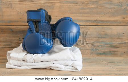 set Taekwondo equipment on a wooden background stock photos. Sports, martial arts. Protective equipment for fight in full contact